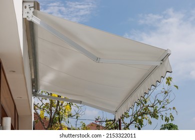 white awning roof against with blue sky. canvas roof sun protection of store.