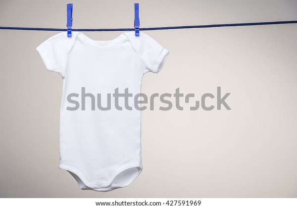 Download White Baby Bodysuit Hanging On Clothesline Stock Photo ...