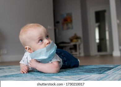 White Baby Boy Wearing And Playing With A Face Mask