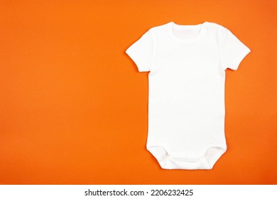 White Baby Girl Or Boy Bodysuit Mockup Flat Lay On Orange Background. Design Onesie Template, Print Presentation Mock Up. Top View. 