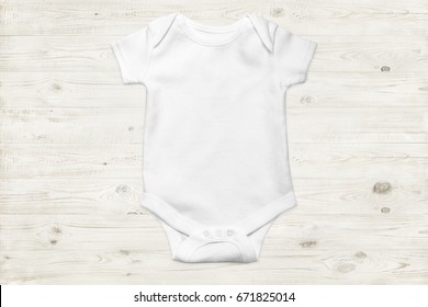 White baby onesie isolated over light wood background. Good for insert your design