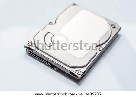 White backdrop frames sleek hard drive, blending modernity with simplicity in a minimalist tech aesthetic.