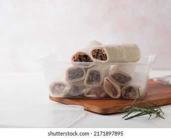 White Background Frozen Kebab or Shawarma Roll in plastic box. small business packaging. Selective focus