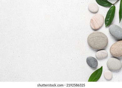 White background with gray pebble stones. Top view, beauty, spa concept - Powered by Shutterstock