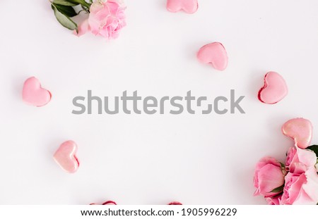 White background with heart shaped macaroons and pink roses for valentines day, mothersday, holiday, gift 
