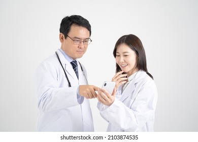 
White background image with male and female doctors who have a meeting by looking at a smartphone