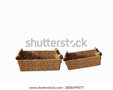 The white background in the image shows a brown, woven multipurpose basket with two handles, featuring a tight weave pattern, suitable for holding various household items.