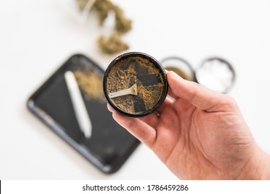 White Background. Marijuana Nature Bud. Kief In Grinder.