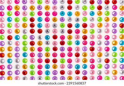 White background of multicolored rhinestones