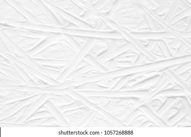 White background with a paint texture. Smears brush artist on the canvas with a pattern of stripes and intersections of endless lines, a template for wallpaper with natural strokes. - Shutterstock ID 1057268888