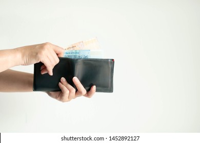 White Background Photo Of Hands Holding A Short Wallet And Another Hand Bring South Korea Money (won Currency) From The Wallet To Pay For Something.