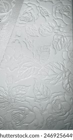 White background with rose pattern.
