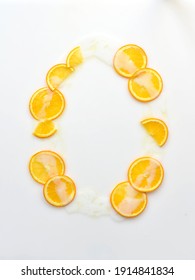 White Background Of Spilled Body Milk With Orange And Oil