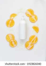 White Background Of Spilled Body Milk With Orange And Oil	