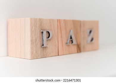 A White Background With Wooden Letter Blocks Spelling 