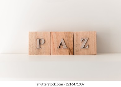 A White Background With Wooden Letter Blocks Spelling 