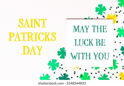 White background with a yellow and green background with a green clover and a yellow star. The words Saint Patrick's Day are written in yellow on the white background - Powered by Shutterstock