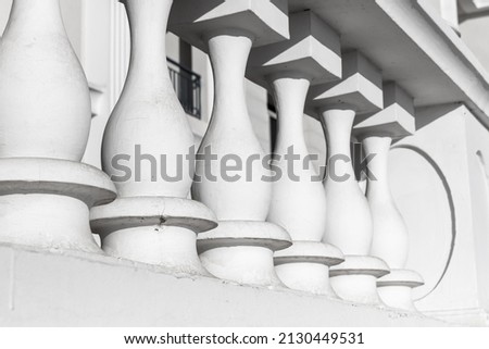 White balcony balusters. Abstract classical architecture exterior fragment
