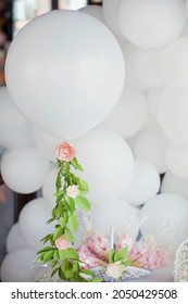 White Balloons With Paper Flower Garland, Sweets And Decorations On A Sweet Table At Birthday White Party