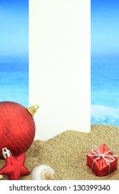 White Banner And Christmas Ornaments On The Beach