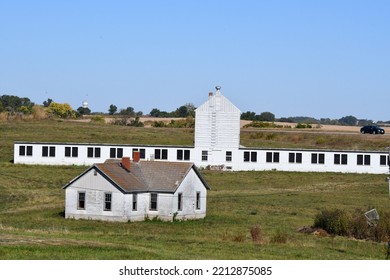 White Barn And House In A Field