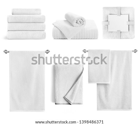 White bath textile items set isolated. Cotton terry towels- hanging, folded, stacked and packed against white background. 