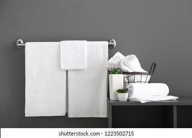 White Bath Towels Near Grey Wall