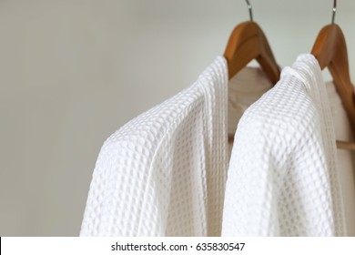 White Bathrobe Hanging On Rack