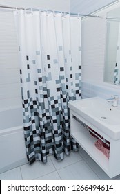 White Bathroom With Black And White Shower Curtain.