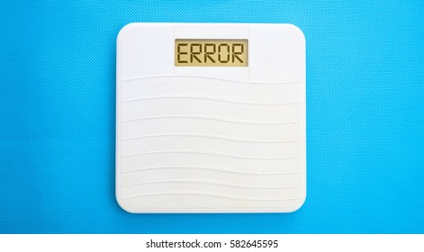 White Bathroom Scale On A Blue Background