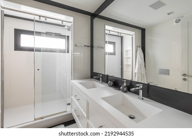 White Bathroom With Shower, Two Sinks And Black Frame Mirror. Modern Interior Of Refurbished Apartment.