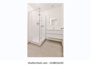 White Bathroom. There Are Large White Tile Wall And Floor.There Have Glass Partition For Shower.Natural Light Transmitted Through The Room