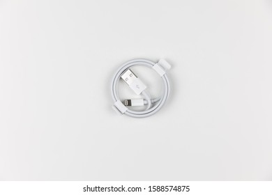 White Battery USB Cable Chord For Smart Phone Charging On White Background, Isolated, Copy Space.