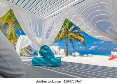 White beach canopies. Luxury beach tents at a resort. Wonderful view of beach scenery, luxury vacation and travel background concept