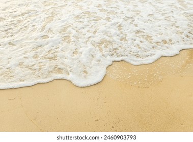 White beach with clear water. Sea waves crashing onto the shore With a yellow sand that looks beautiful. Background that is suitable for Long summer holiday, vacations, family activities. Sand texture - Powered by Shutterstock