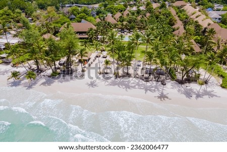 White Beach Koh Kood Island Thailand Trat, tropical beach with palm trees and a turqouse colored ocean on a sunny day, Ko Kut Island with coconut palm trees on the beach, drone aerial view