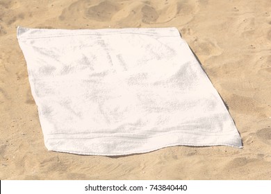 White Beach Towel On Sand