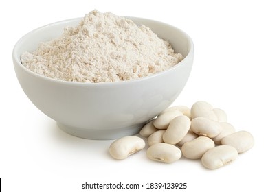 White bean gluten free flour in a white ceramic bowl next to a pile of white beans isolated on white.