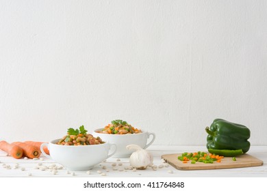 White Beans With Vegetables On White Wood
