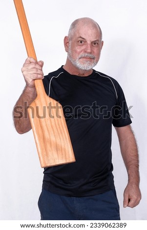white bearded man holding wooden paddle water navigation used in boat and canoes