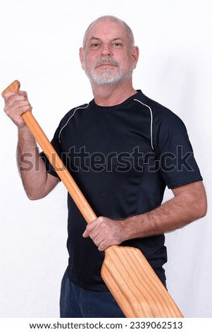 white bearded man holding wooden paddle water navigation used in boat and canoes