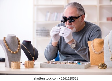 White bearded old jeweler at workshop 
