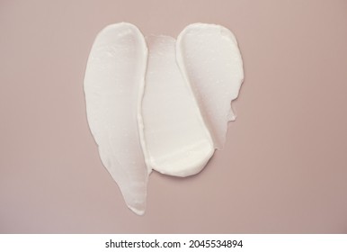 White Beauty Cream Lotion Highlighter Smear Swatch Smudge On Pink Background.