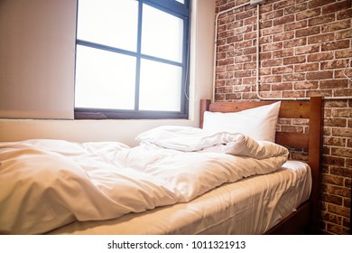 white bed in front of a window