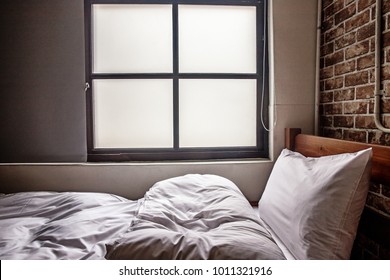 white bed in front of a window