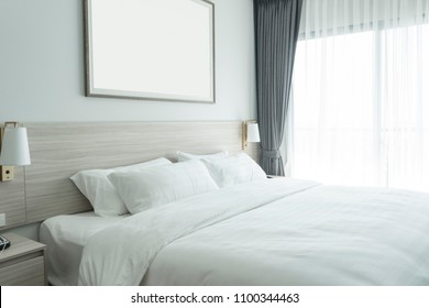 White Bedding And Pillow In Hotel Room, Pillows On The Bed With Picture Frame On Wall.