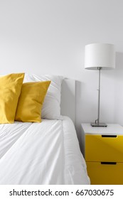 White Bedroom With Bed, Lamp And Modern, Yellow Side Table