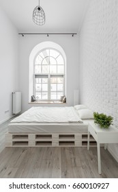 White Bedroom With Pallet Bed And Brick Wall