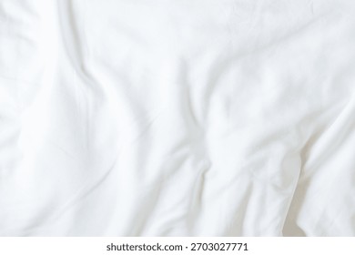 White bedsheet background, bed sheet cotton fabric texture, wrinkled duvet, crumpled satin blanket comforter cloth used in hotel, resort or home interior for bedding sleep comfort