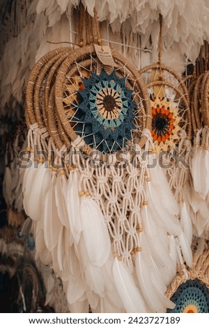 White beige dream catchers hanging on the counter of a street store